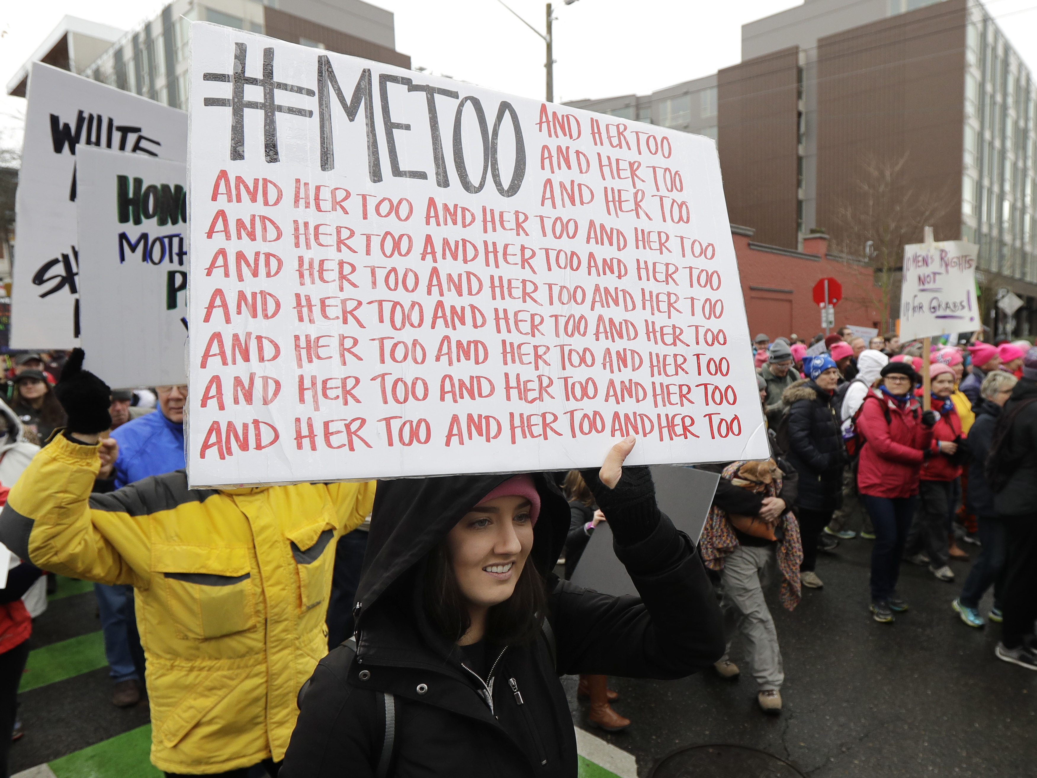 caption: Marchers protest sexual harassment in January 2018 in Seattle.