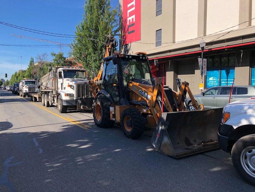 caption: SDOT equipment, after driving right up to barriers at the CHOP, eventually retreated to this point a few blocks east.