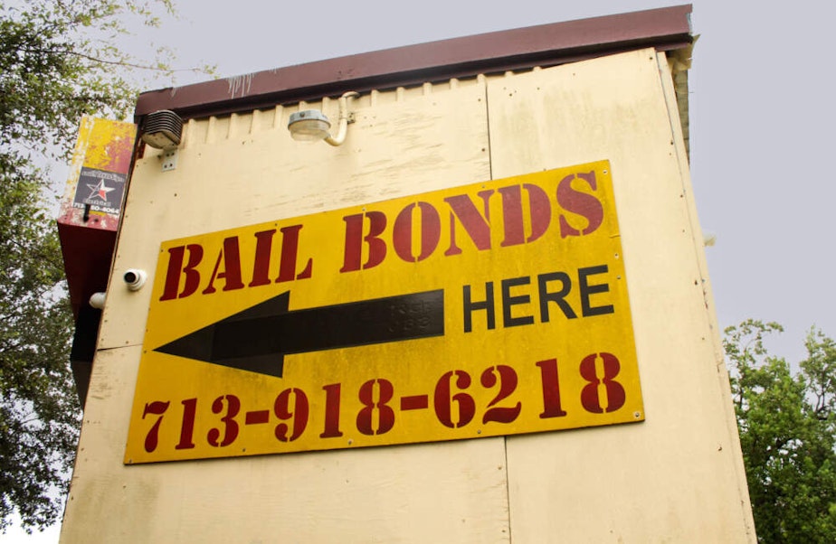 caption: A sign advertises bail bonds in Harris County, Texas. (Wilder Fleming/Here & Now)