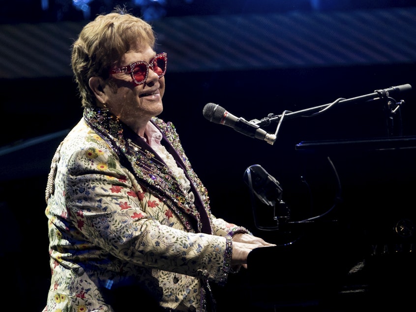 caption: Elton John performs during his "Farewell Yellow Brick Road" tour on Jan. 19 in New Orleans. Despite being vaccinated and boosted, John has contracted COVID-19 and postponed two farewell concert dates in Dallas. John "is experiencing only mild symptoms," according to a statement.