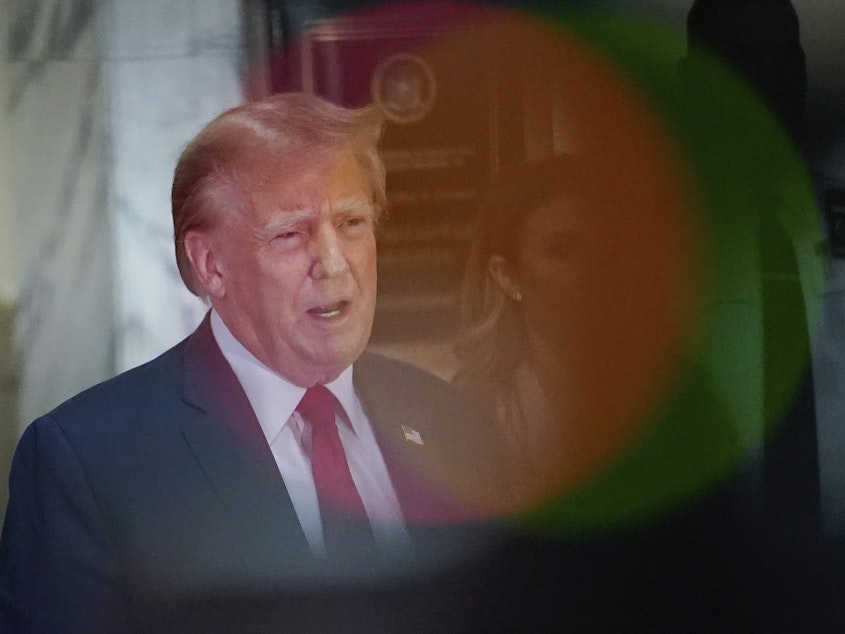 caption: Former President Donald Trump speaks after exiting the courtroom for a break at New York Supreme Court on Dec. 7 in New York.