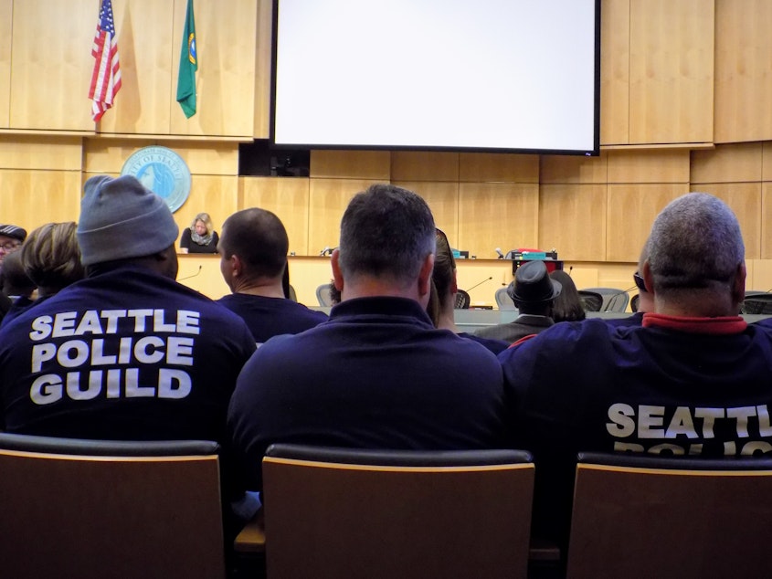 caption: Members of the Seattle Police Officers Guild packed the Council Chamber before a vote on a union contract between the guild and the city in 2018.