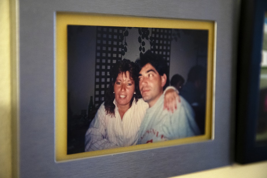 caption: A photograph of Marta, left, and Omar, in the early 90’s is displayed in their living room on Tuesday, September 26, 2023, at their apartment in Everett. 