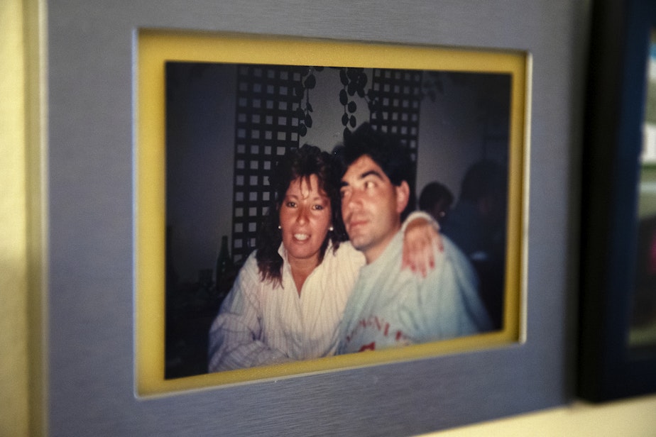 caption: A photograph of Marta, left, and Omar, in the early 90’s is displayed in their living room on Tuesday, September 26, 2023, at their apartment in Everett.