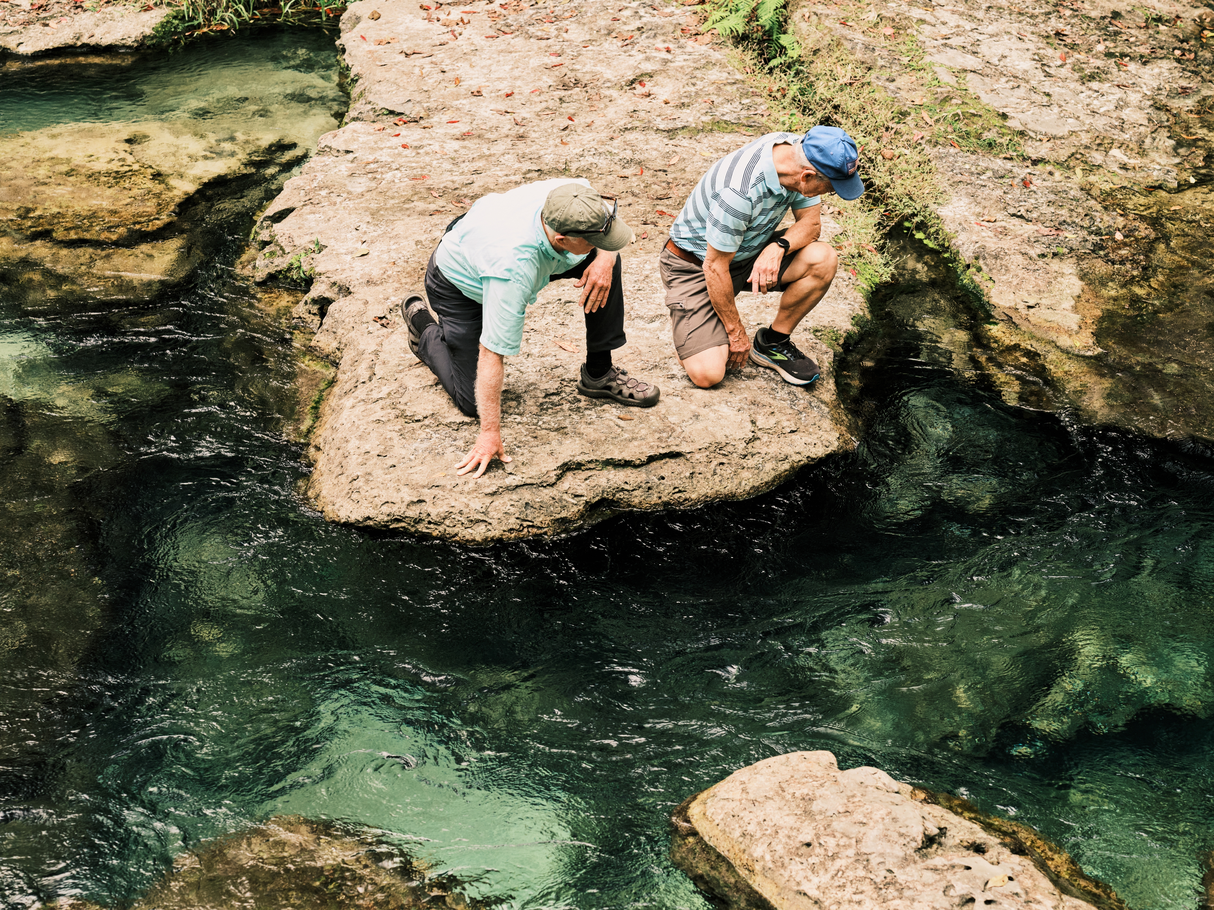 caption: Jay Exum and Mike Cliburn, board members of the Friends of the Wekiva River, examine the fresh water of the spring on Dec. 11, at Rock Springs in Apopka, Fla.