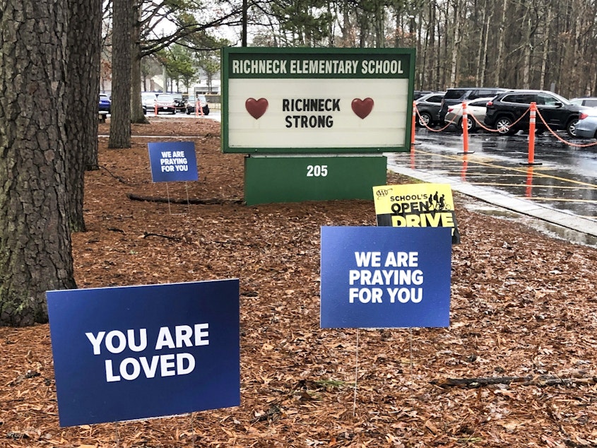 caption: Signs stand outside Richneck Elementary School in Newport News, Va., Jan. 25, 2023.