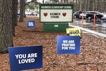 caption: Signs stand outside Richneck Elementary School in Newport News, Va., Jan. 25, 2023.