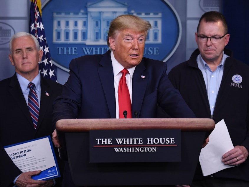 caption: President Trump, flanked by FEMA Administrator Peter Gaynor (right) and Vice President Pence, speaks during a daily briefing on the coronavirus.