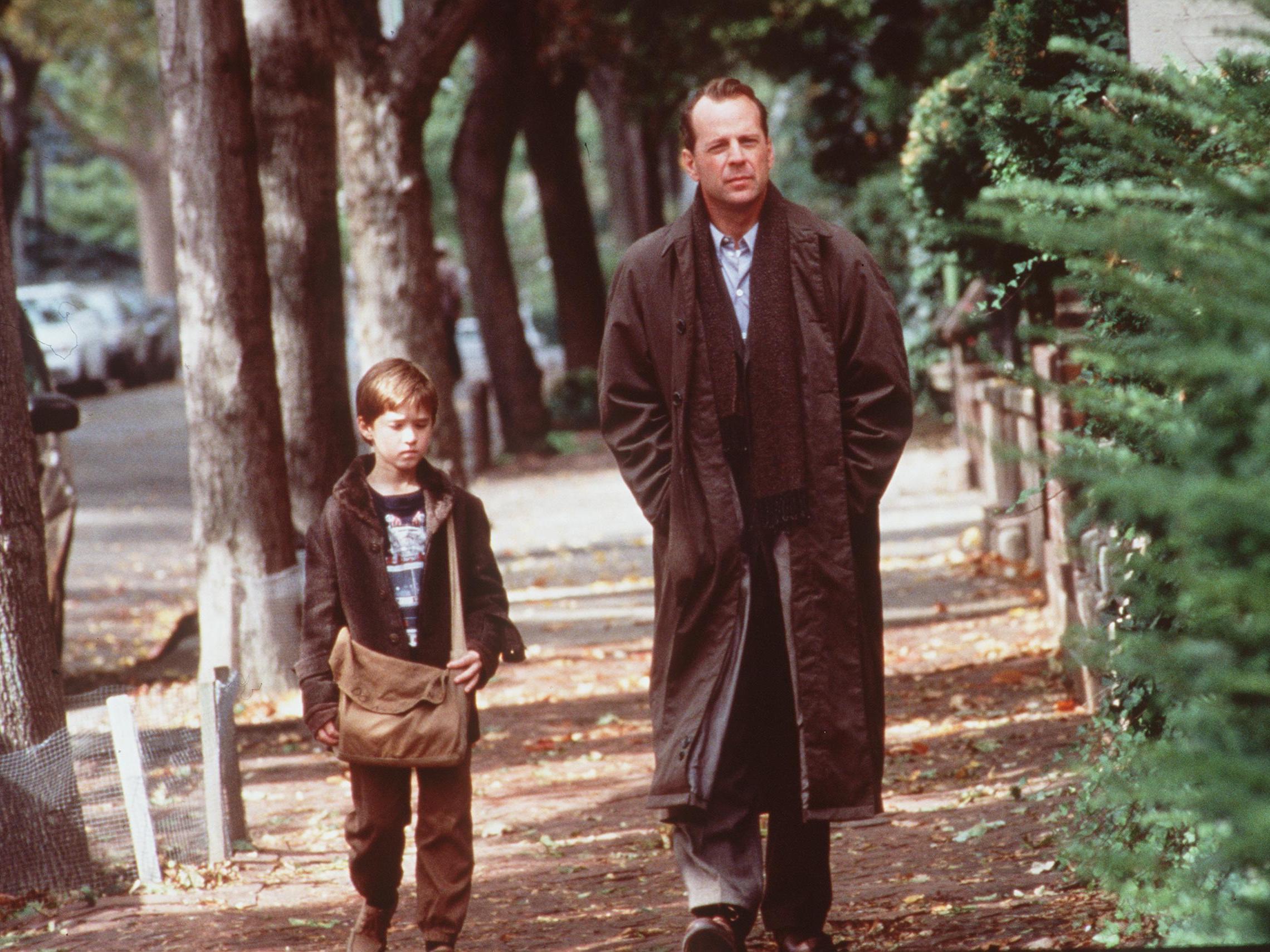 caption: Haley Joel Osment And Bruce Willis in <em>The Sixth Sense</em> in 1999.
