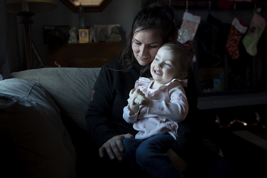 caption: Ferrari Spence, 29, sits with her 2-year-old daughter Danni, at their home on Friday, December 16, 2022, in Marysville.  
