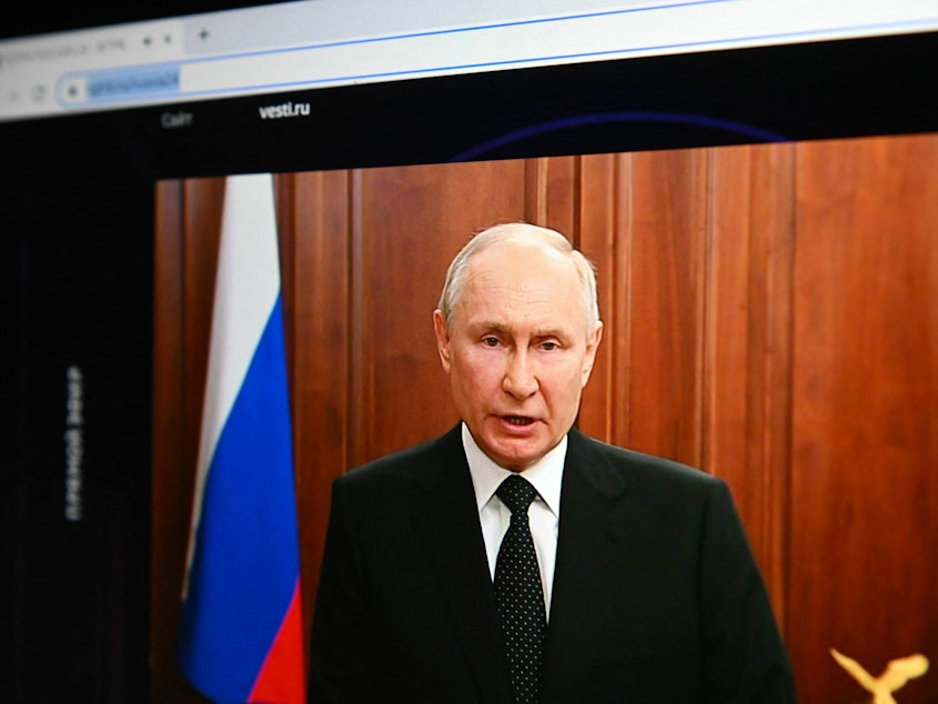 caption: Russia's President Vladimir Putin, seen on a laptop screen, makes a statement in Moscow on Saturday as Wagner Group forces stage a rebellion.