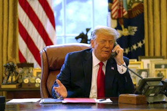 caption: In this image released in the final report by the House select committee investigating the Jan. 6 attack on the U.S. Capitol, President Donald Trump talks on the phone to Vice President Mike Pence from the Oval Office of the White House on Jan. 6, 2021. 