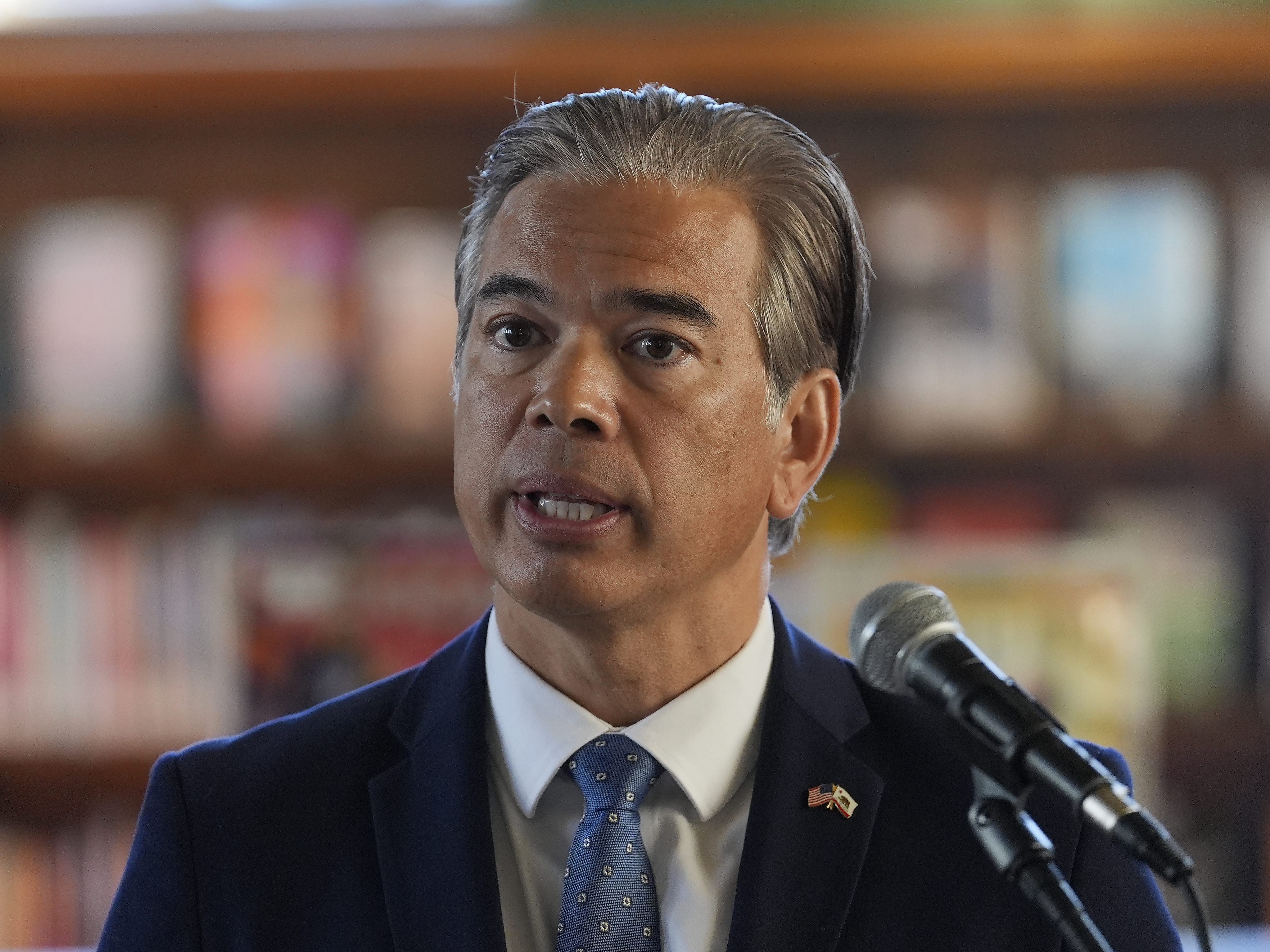 caption: California Attorney General Rob Bonta at a news conference in San Francisco on Dec. 4, 2024. Bonta is leading 20 state attorneys general in a lawsuit seeking to block federal health officials from further sharing Medicaid data and DHS from using it for immigration enforcement.