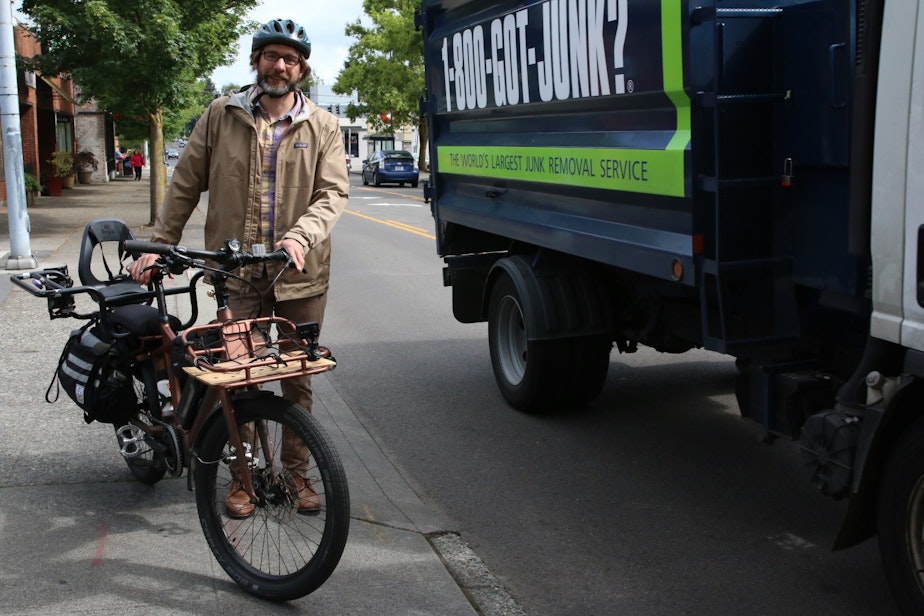 caption: Tim Fliss pauses in his morning commute down 35th Avenue NE
