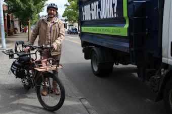 caption: Tim Fliss pauses in his morning commute down 35th Avenue NE