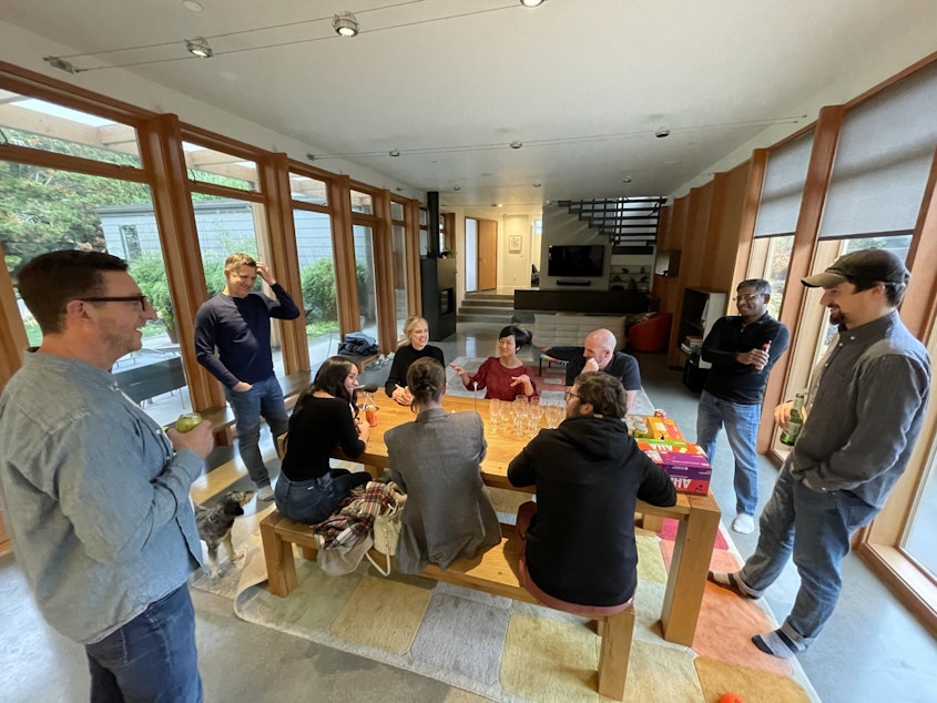 caption: A small gathering of Crowd Cow employees share a meal at CEO Joe Heitzeberg's house on Mercer Island