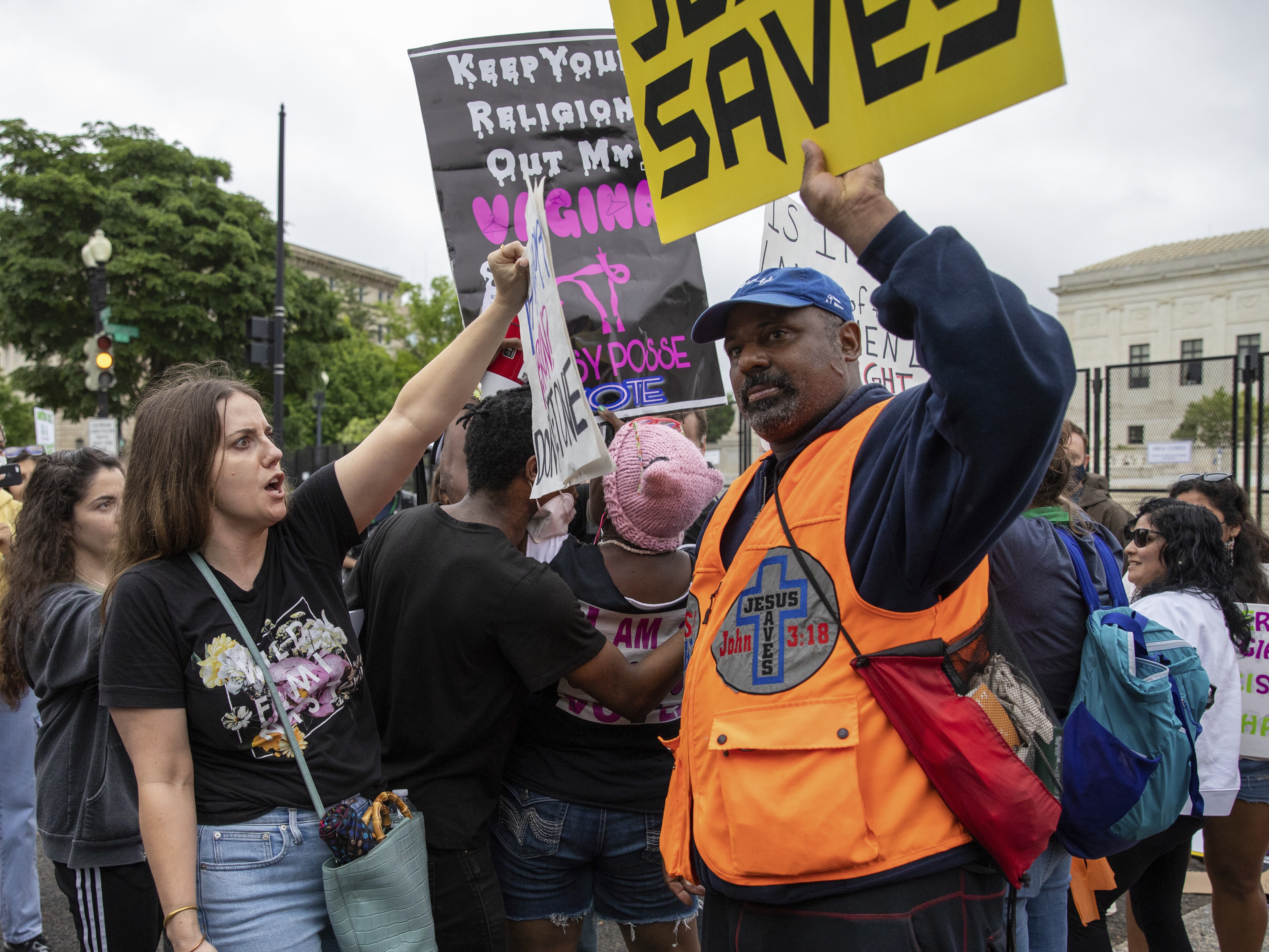 caption: An abortion-rights protester, left, faces off against an anti-abortion protester in front of the U.S. Supreme Court in 2022.