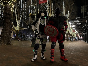 caption: Justin Service (left) and Red Ranger (right) pose at the end of a nightly patrol in Pioneer Square. 
