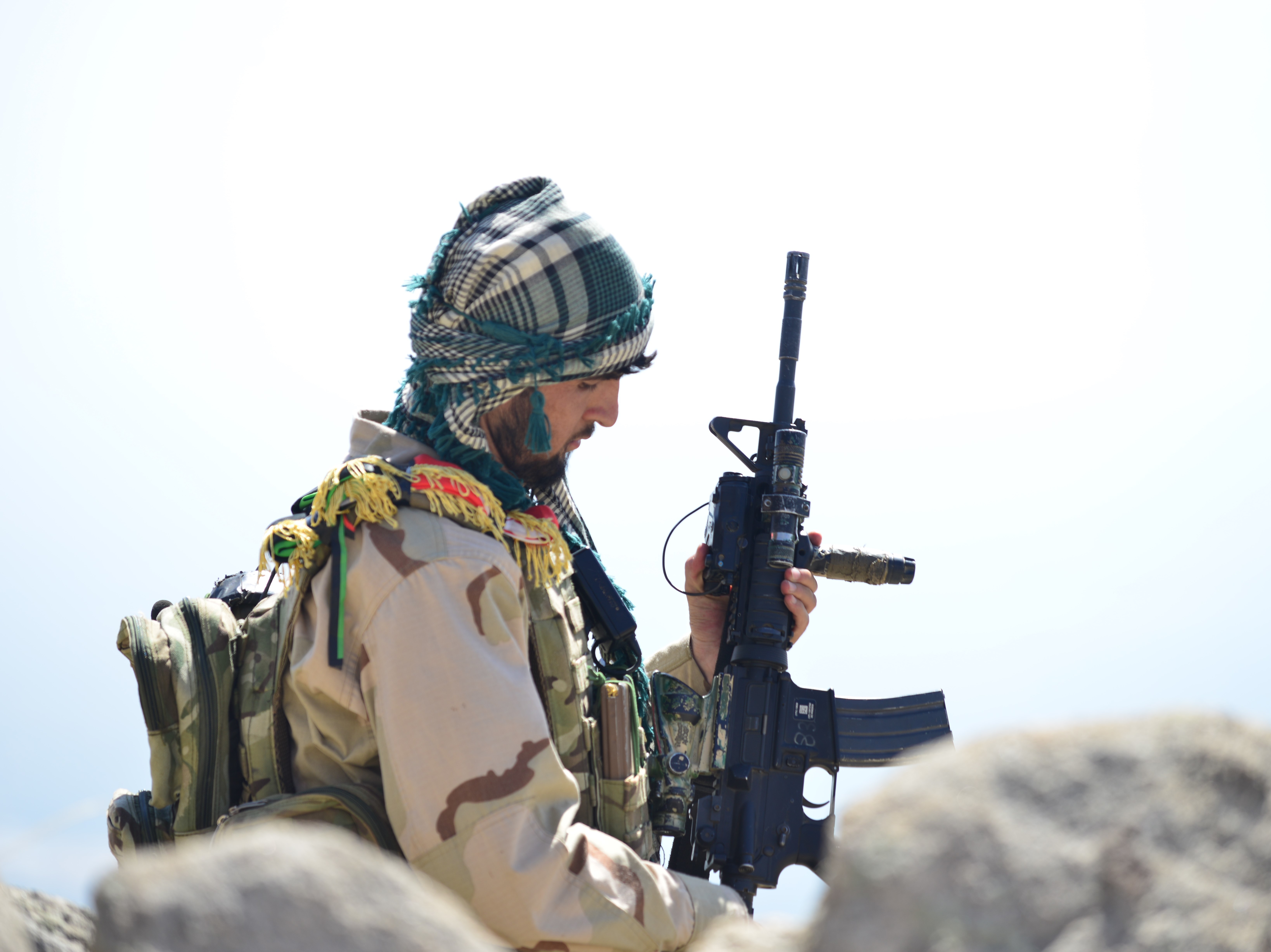 caption: An Afghan anti-Taliban fighter is seen on a hilltop in Anaba district in Afghanistan's Panjshir province on Wednesday.