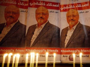 caption: Candles burn in a memorial to slain journalist Jamal Khashoggi outside Saudi Arabia's Consulate in Istanbul in October 2018.