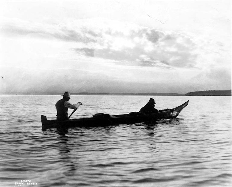 caption: Lummi men trolling for salmon from canoe, near Bellingham, Washington, ca. 1900. 