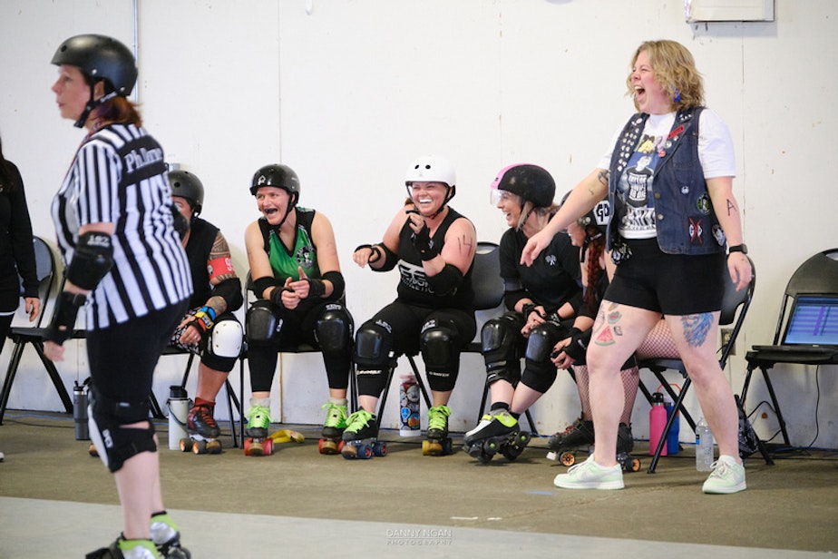 caption: The "Brutal Poodles" react to shenanigans on the track.
