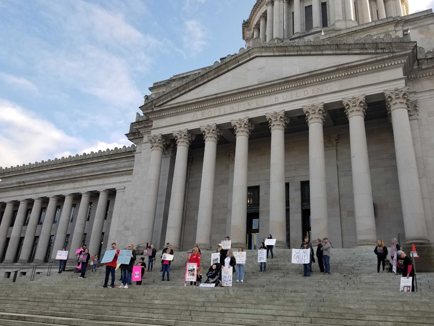 caption:  A group of people who support HB 1397, dubbed by some the "Oakley Carlson Act" stand on the steps of the Washington Statehouse a week before the bill's first scheduled committee hearing. 