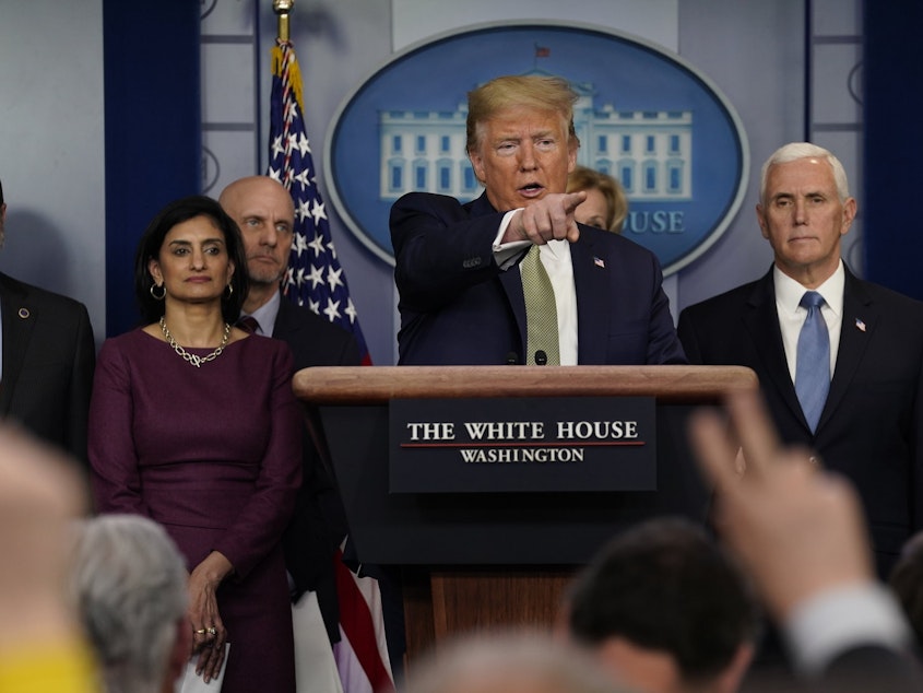 caption: President Donald Trump speaks Tuesday during a press briefing with the coronavirus task force at the White House.