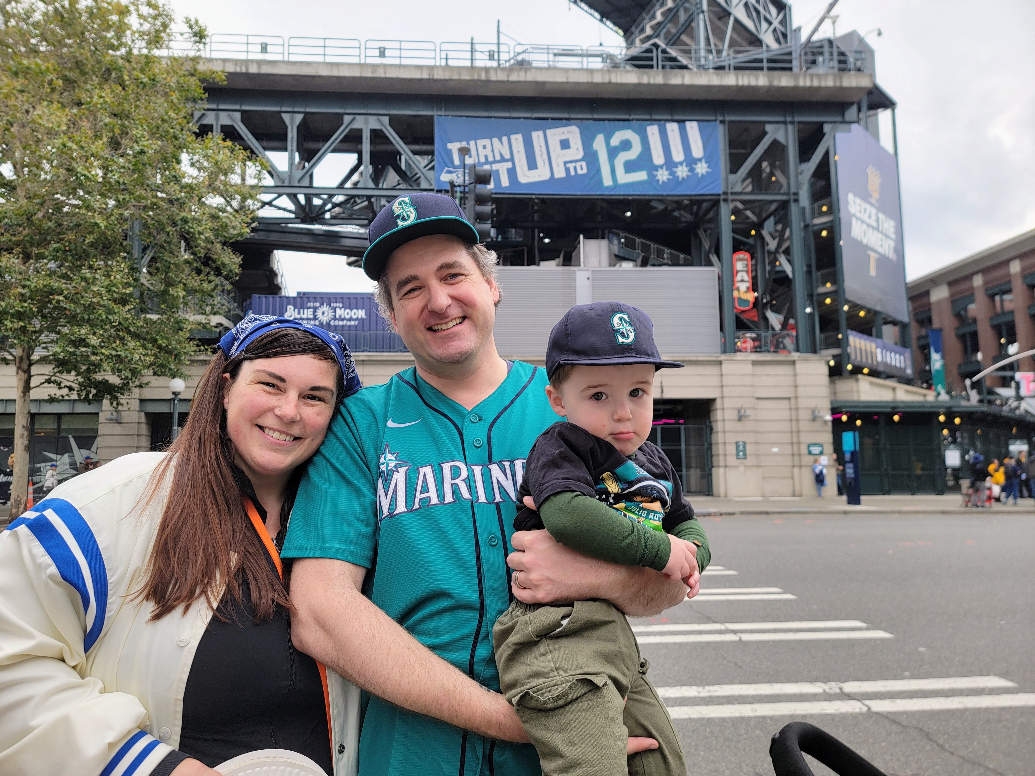 caption: Lee Chilcott (left), Clint, and Charlie got selfies with Humpy Salmon and Mariner Moose before the game on Thursday, Oct. 16, 2025. 