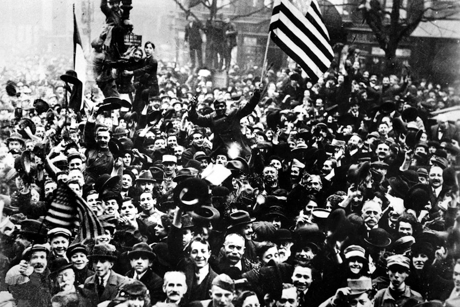 caption: Americans join the celebration on the Grand Boulevard on Armistice Day for World War I in Paris, France, Nov. 11, 1918. (AP Photo)