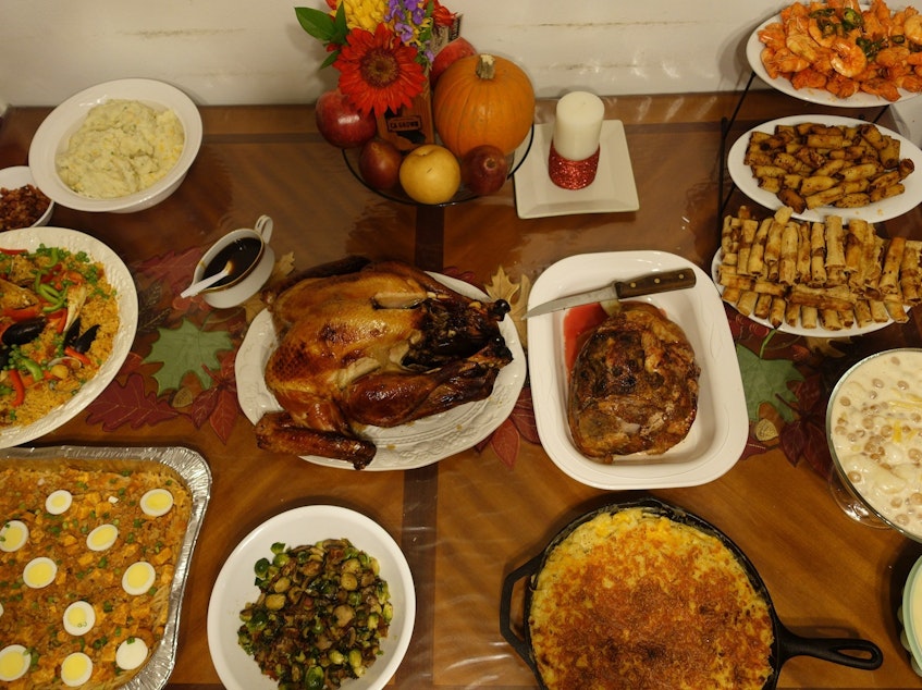 caption: PJ Policarpio's Thanksgiving spread, last year. The feast includes Filipino paella, a noodle dish called palabok and lumpia, fried egg rolls.