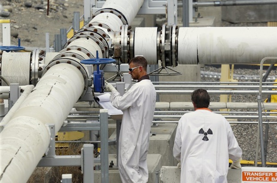 caption: <p>In this July 9, 2014, file photo, workers wearing protective clothing and footwear inspect a valve at the "C" tank farm on the Hanford Nuclear Reservation near Richland, Wash.</p>