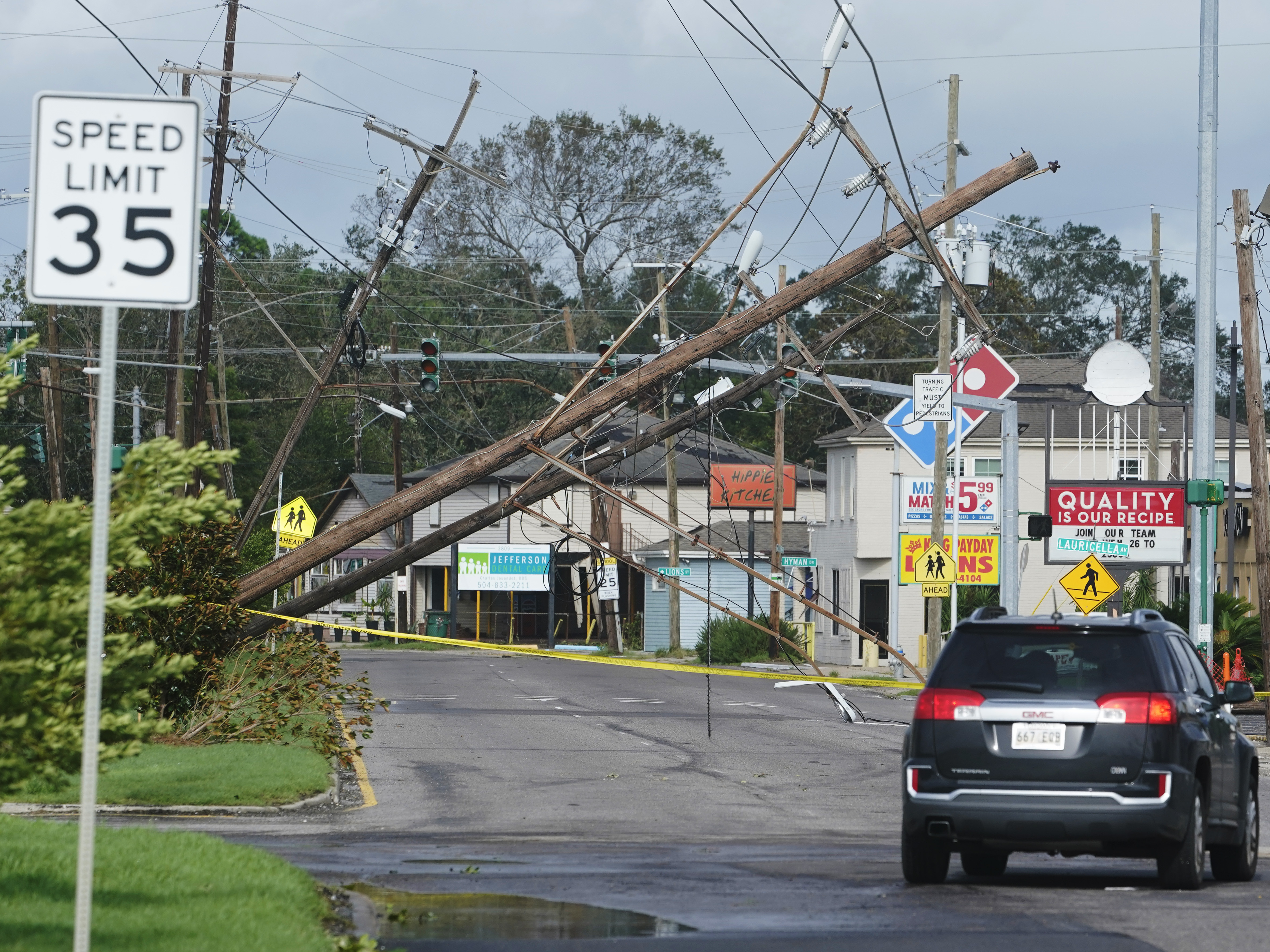 caption: Hurricane Ida leaves downed power lines in its wake Monday in Metairie, La. The one-two punch of a natural disaster and the pandemic is complicating efforts to evacuate hospitals, seek shelter and administer COVID-19 vaccines.