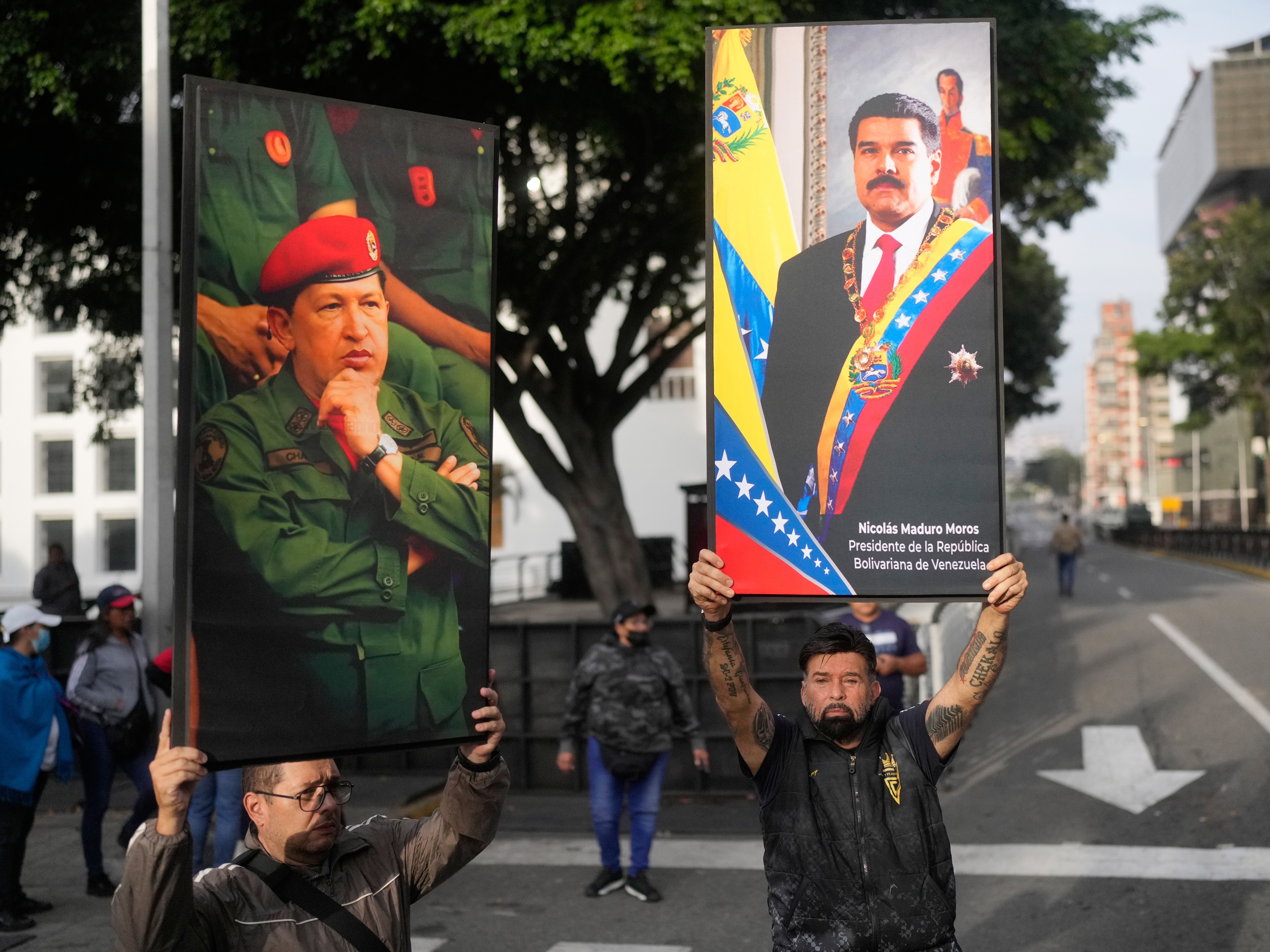 caption: Government supporters display posters of Venezuelan President Nicolás Maduro, right, and former President Hugo Chávez in downtown Caracas, Venezuela, Saturday, Jan. 3, 2026, after U.S. President Donald Trump announced that Maduro had been captured and flown out of the country.
