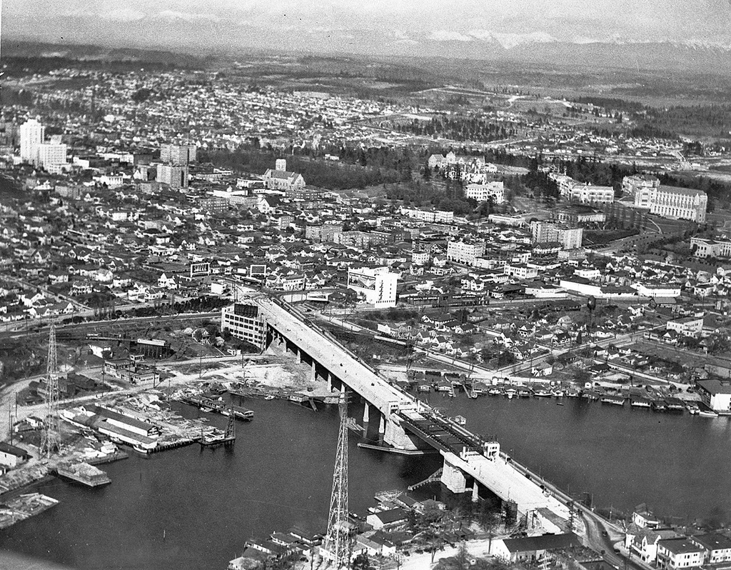 caption: This 1933 shot shows the University Bridge in Seattle under construction. City planners are deciding how the city will change in the course of the next 30 years.