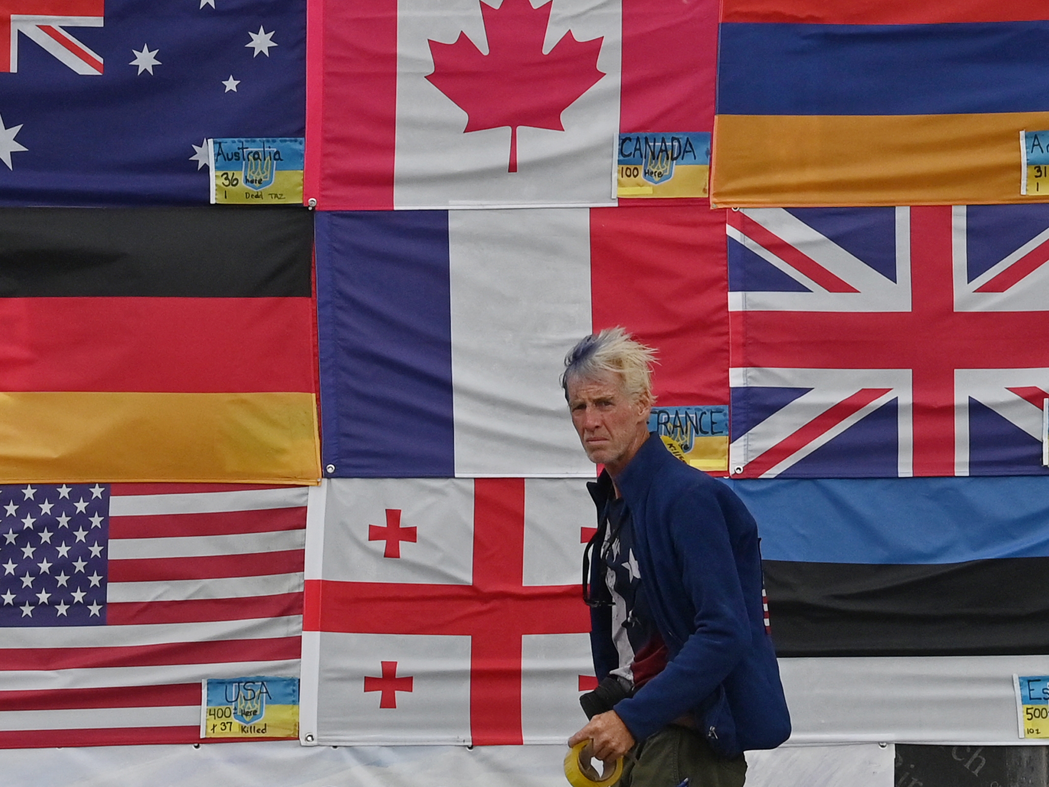 caption: This photograph taken on June 23, 2022 in Ukraine, shows U.S. citizen Ryan Routh sticking up national flags of the countries helping Ukraine. Routh, now 58, faces federal charges on the attempted assassination of former President Donald Trump at his West Palm Beach, Fla. golf course on September 15, 2024.