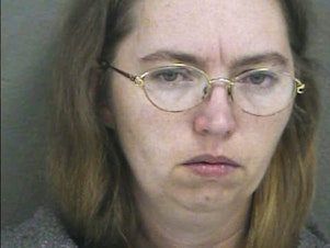 caption: In this handout photo provided by the Wyandotte County Sheriff's Department, Lisa Montgomery appears in a booking photo from 2004.