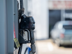 caption: A gas pump is seen at a Chevron gas station on June 9 in Houston, Texas. Gas prices nationally hit an average of $5 a gallon, according to AAA.