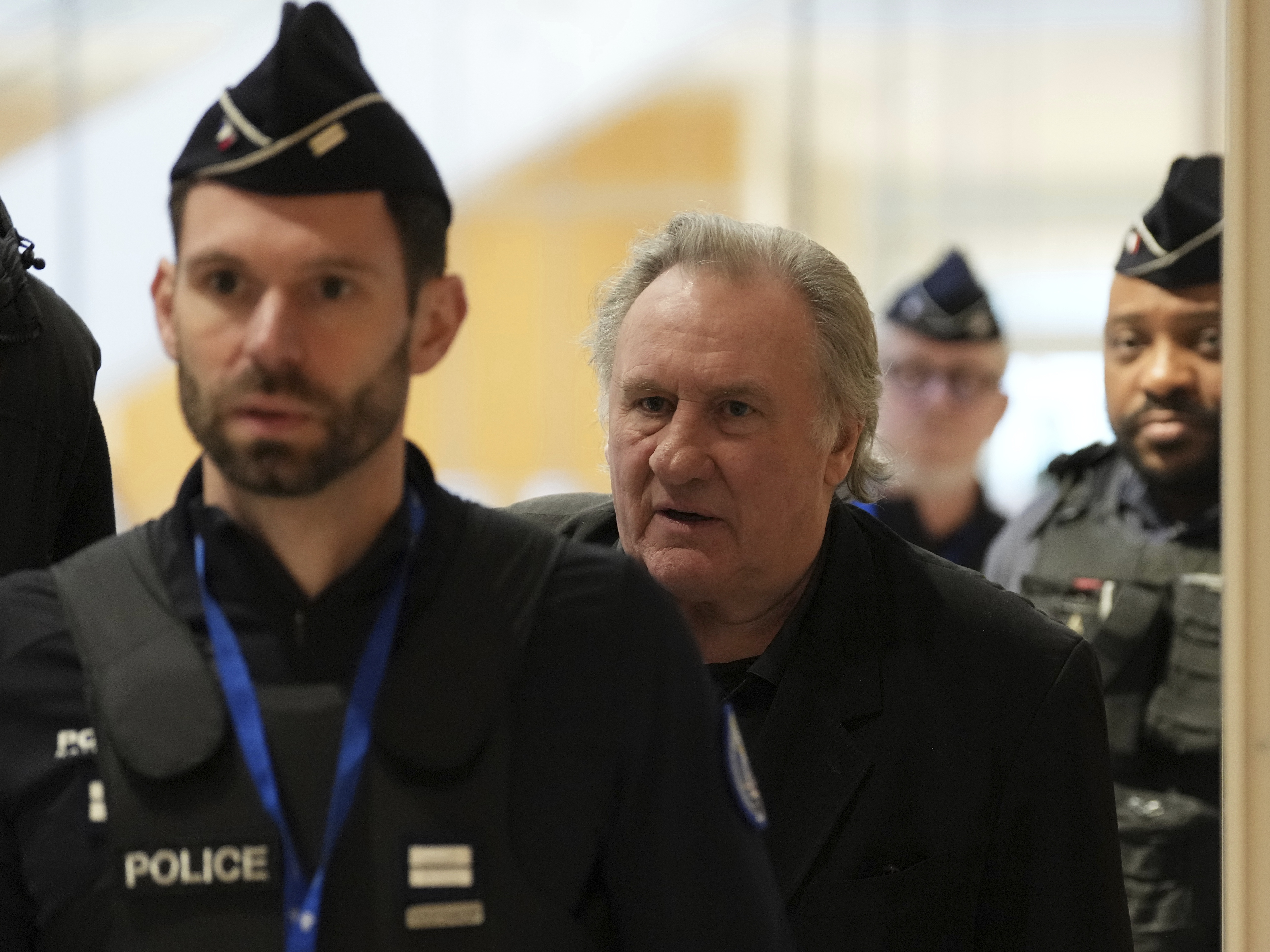 caption: French actor Gérard Depardieu leaves for a break during his trial for the alleged sexual assaults of two women on a film set in 2021.