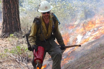 caption: <p>A member of the Wolf Creek Hotshots uses a drip torch to ignite the forest floor during a prescribed burn near Sisters, Oregon.</p>