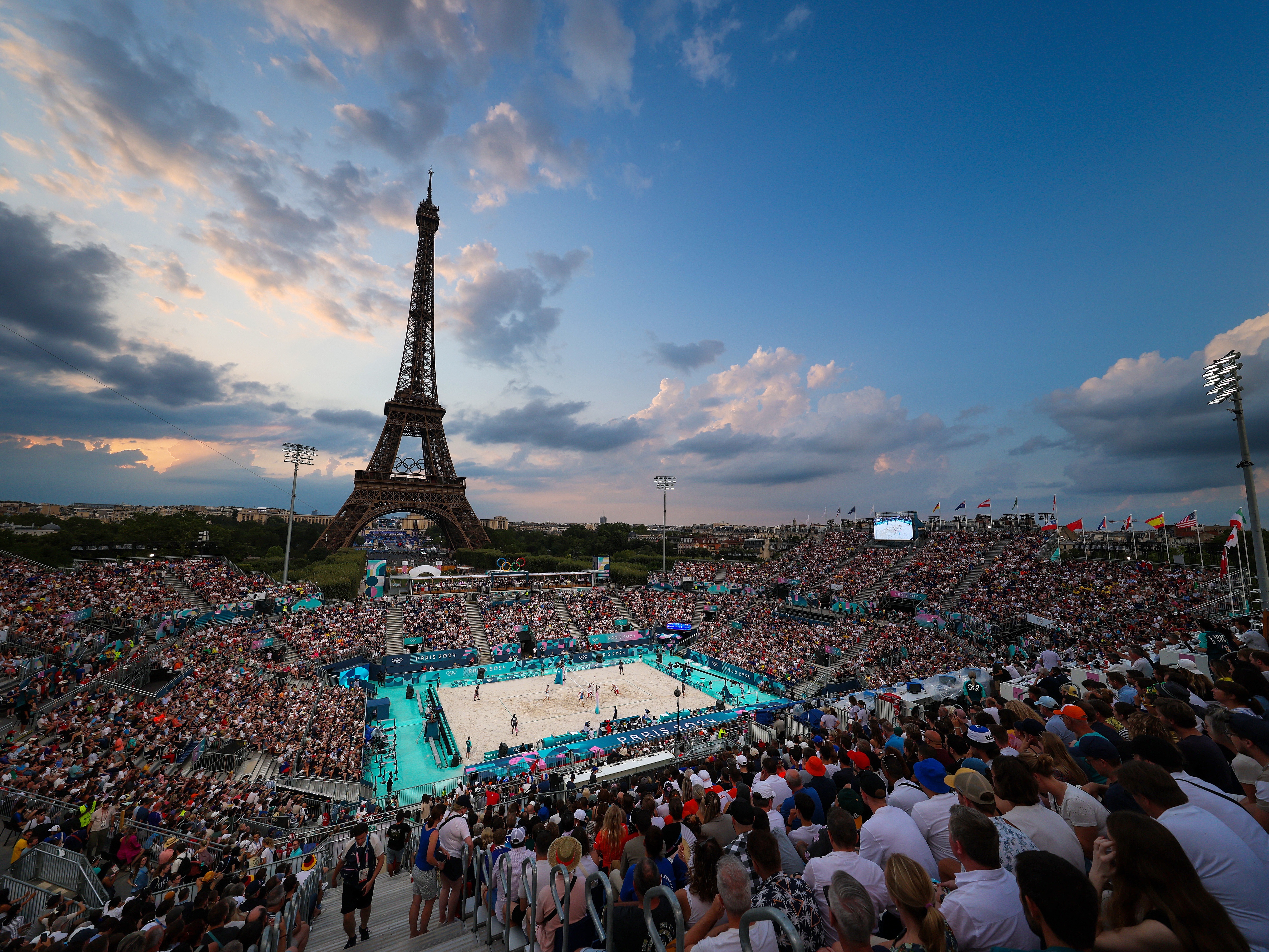 caption: The beach volleyball venue, with the Eiffel Tower as a backdrop, has turned into a hot ticket at the Paris Summer Olympics.