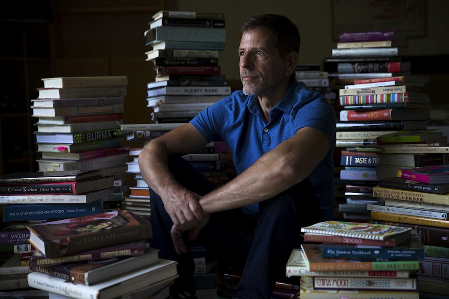 caption: Chef Jerry Traunfeld is portrayed sitting among the many cookbooks that he has been collecting since the mid-70s at his home on Wednesday, July 31, 2019, in Seattle. 