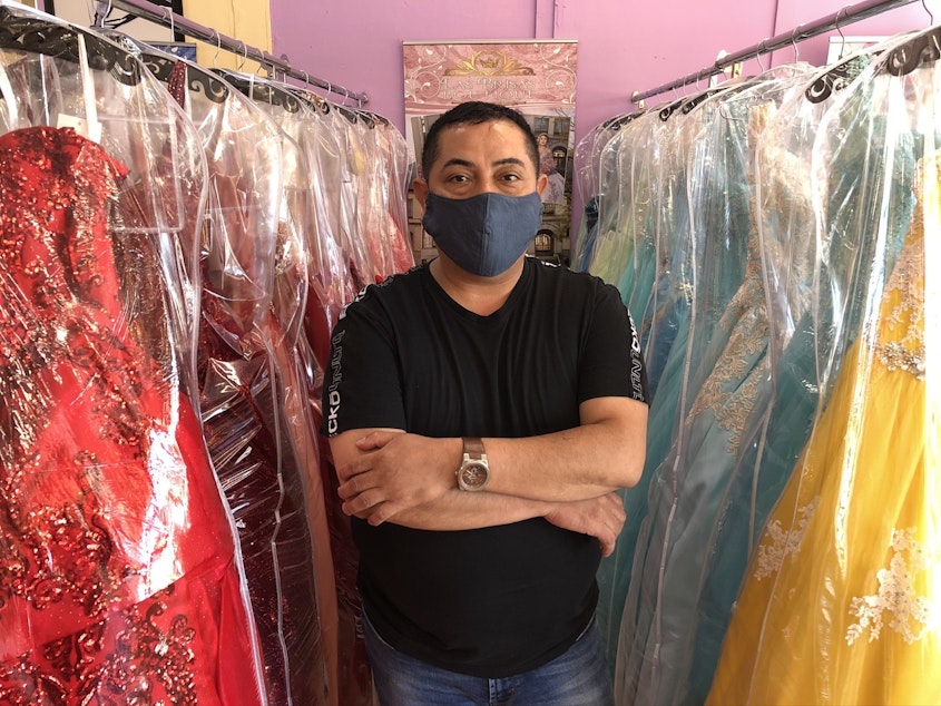 caption: Ramiro Alvarez of Las Brisa's Boutique in White Center. Many of his customers have stopped making payments on wedding and quinceañera dresses, because those ceremonies aren't happening during the pandemic.