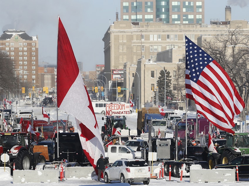 caption: Demonstrators rally against provincial and federal COVID-19 vaccine mandates and in support of Ottawa protestors on Friday outside the Manitoba Legislature in Winnipeg.