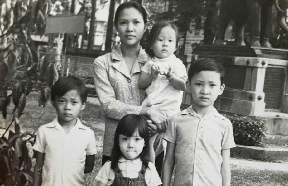caption: The Ton family in the 1970s, in South Vietnam, while Liem Ton was held in prison. Front row (from left to right): Danny Ton, Camtu Tonnu, and Quan Ton. Back row: Lê Nguyen (left) holding Khanh Tonnu (right).