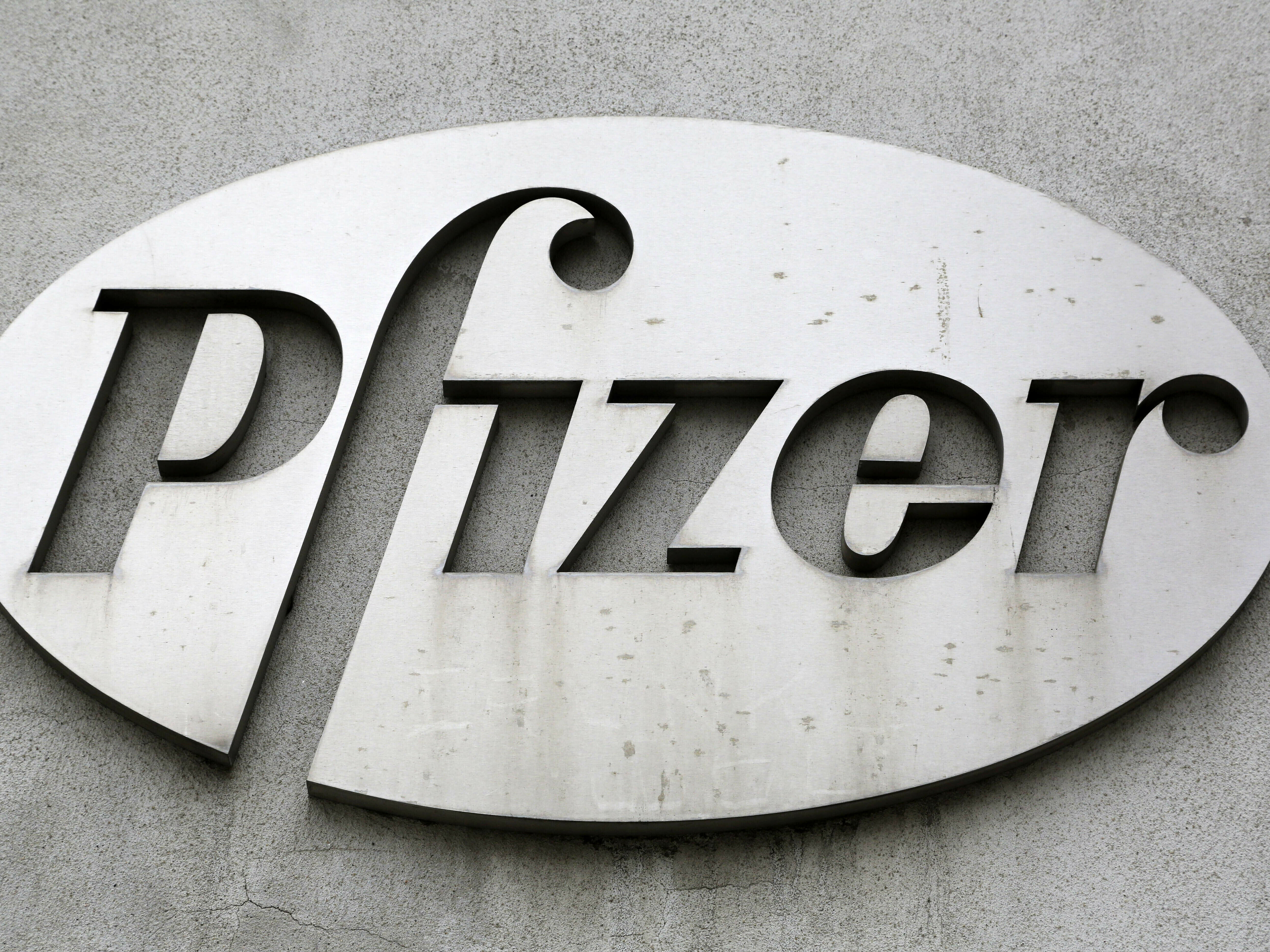 caption: The Pfizer logo is displayed on the exterior of a former Pfizer factory, on May 4, 2014, in the Brooklyn borough of New York.