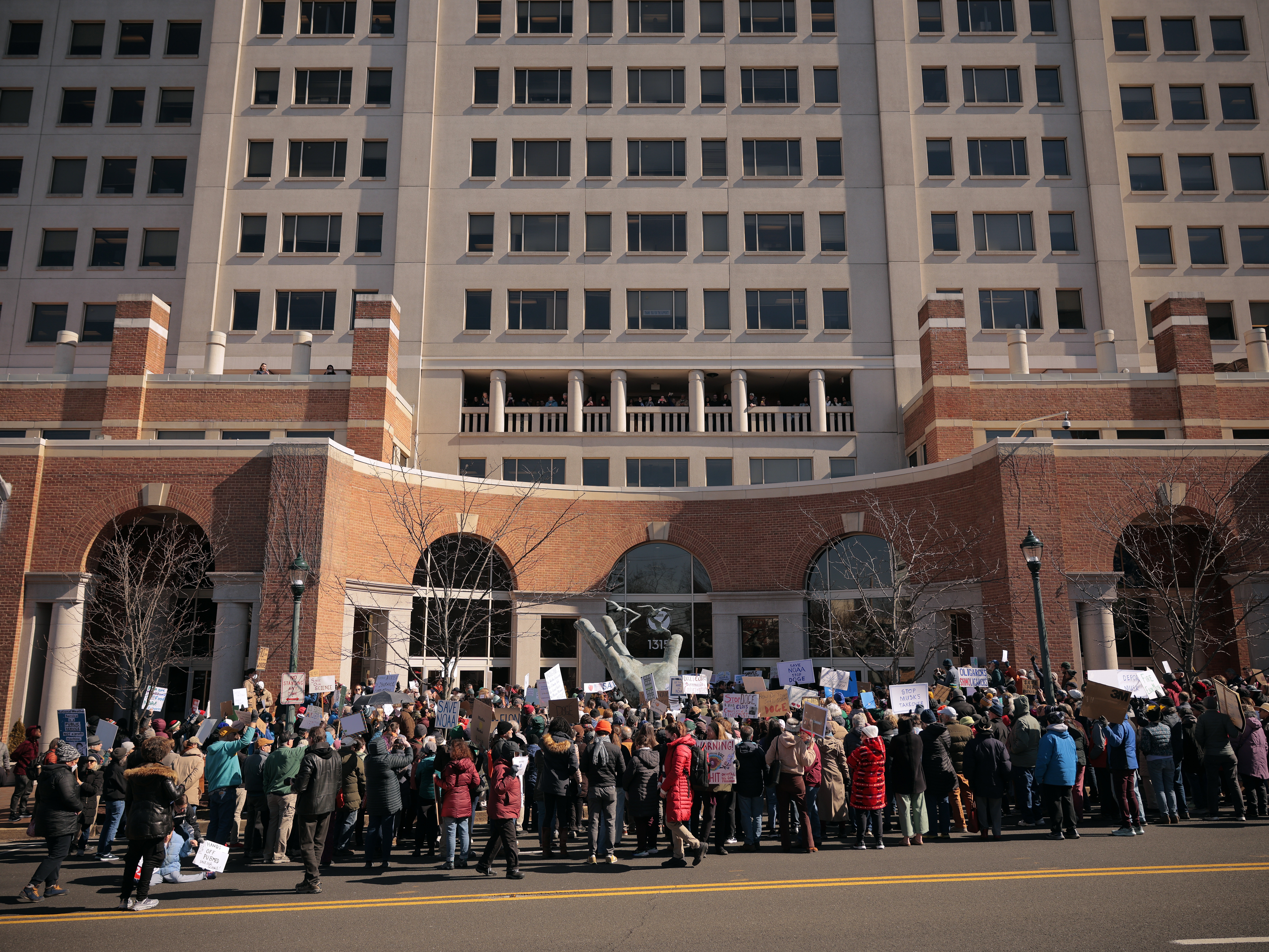 caption: Hundreds of demonstrators gathered outside the headquarters of the National Oceanic and Atmospheric Administration in March to protest Department of Government Efficiency (DOGE) cuts to the agency. The Trump administration continues to make major staffing and programming changes at the agency.