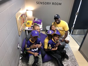 caption: Sheletta and Shawn Brundidge, alongside their four children, were the first fans to use the sensory room at the Minnesota Vikings' U.S. Bank Stadium. Opened during the August pre-season, the space comes with trained therapists and provides fans, including those with autism, a break from the excitement of the game.