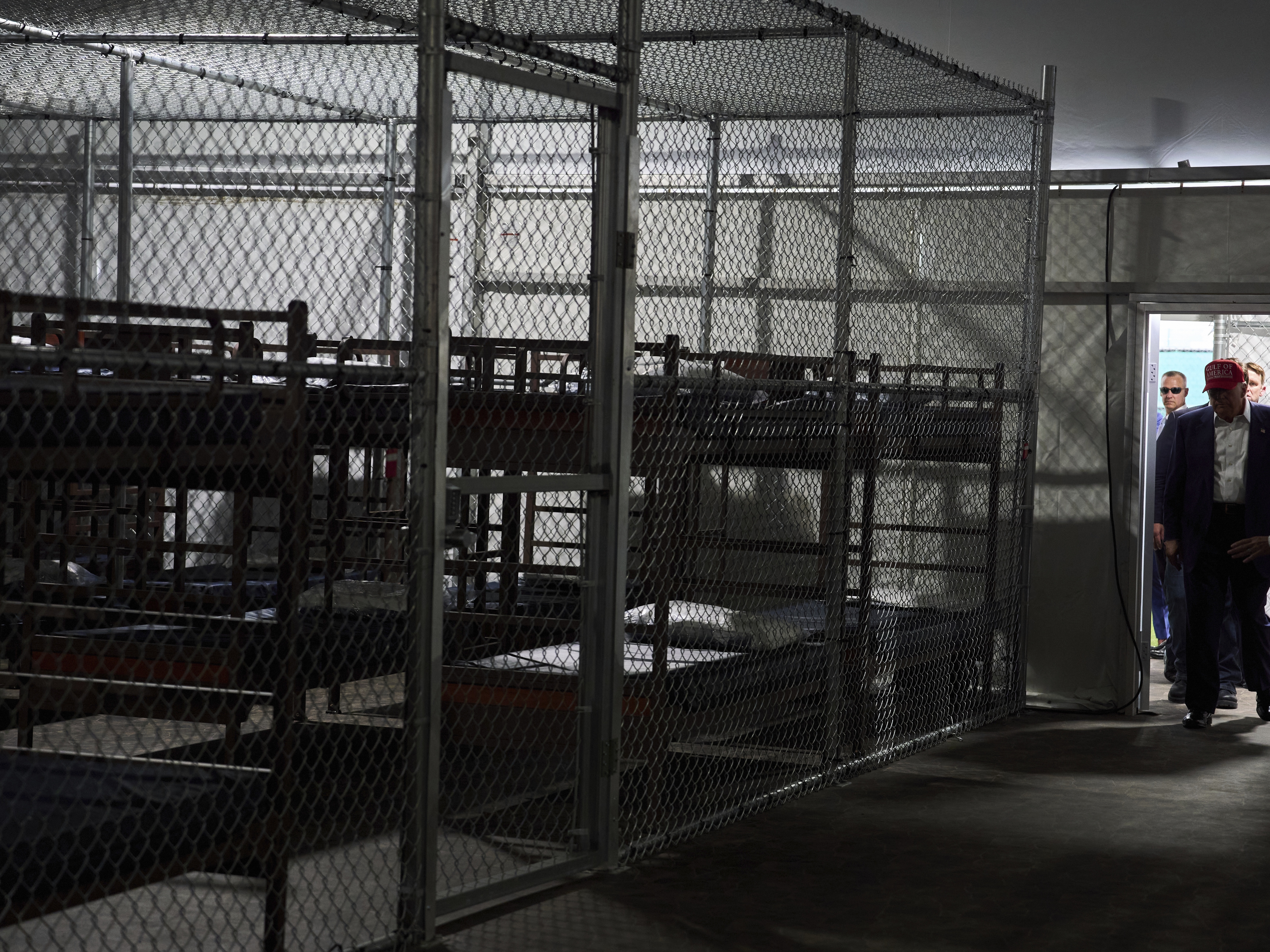 caption: President Trump tours "Alligator Alcatraz," a new migrant detention facility at Dade-Collier Training and Transition facility, on July 1, 2025, in Ochopee, Fla.