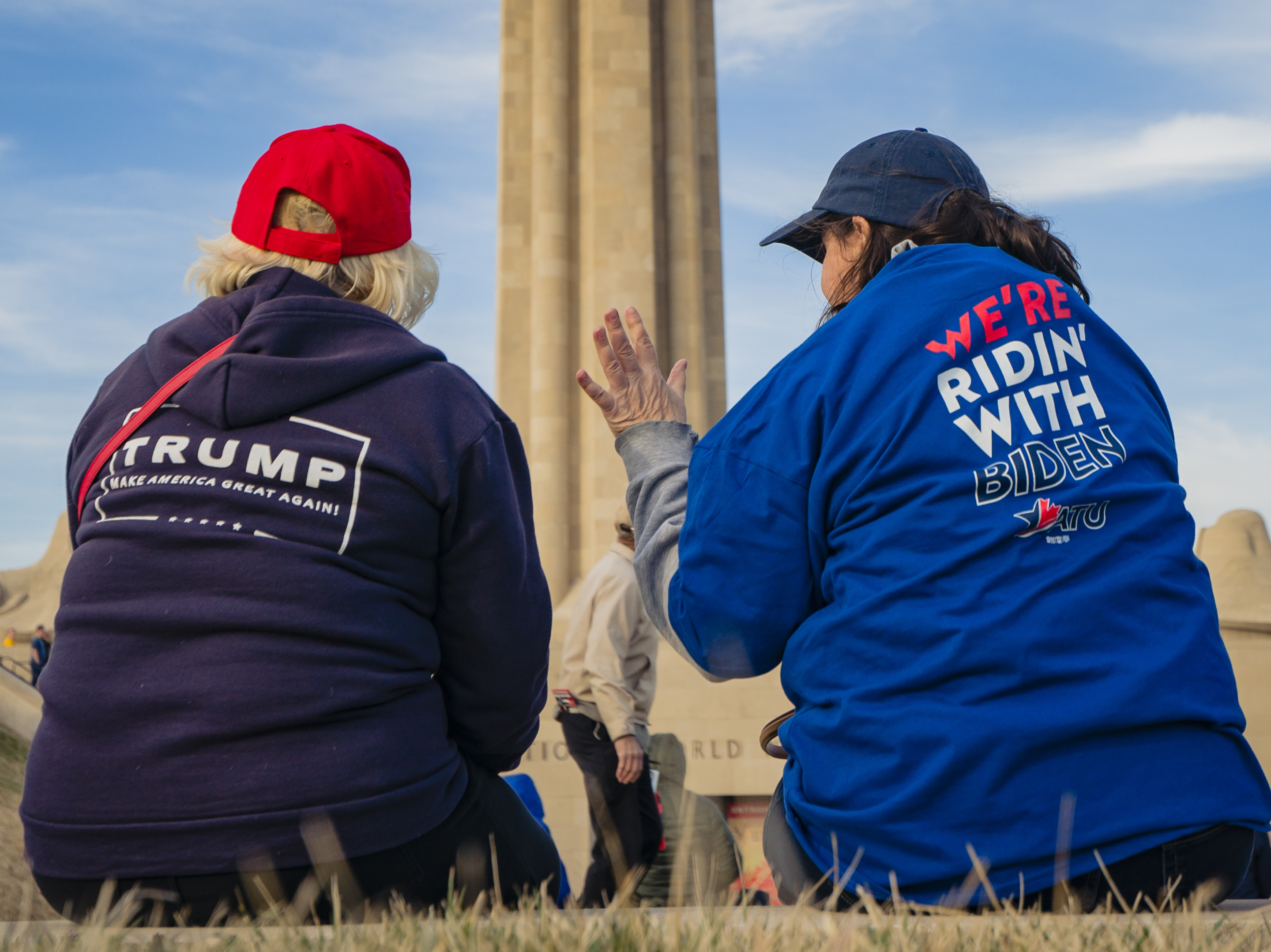 caption: Supporters of President Trump and his Democratic challenger, former Vice President Joe Biden, talk in Kansas City, Mo.